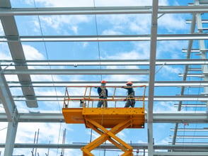 workers-install-lighting-fixture-in-a-hug-industrial-warehouse-using-hydraulic-scissor-lift-work